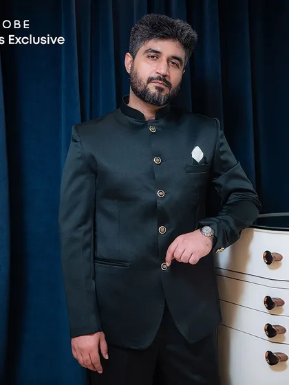 A classic Jodhpuri suit in a deep bottle green. This timeless piece is perfect for formal dinners, engagements, or any event where elegance is key.