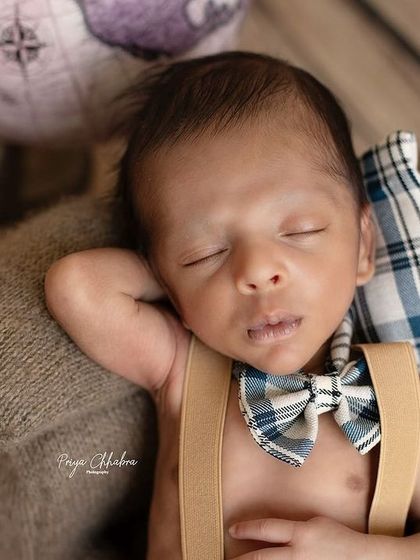 A close-up on our little traveler's face, highlighting the sweet bow tie and peaceful expression. These details are what make each photo special.