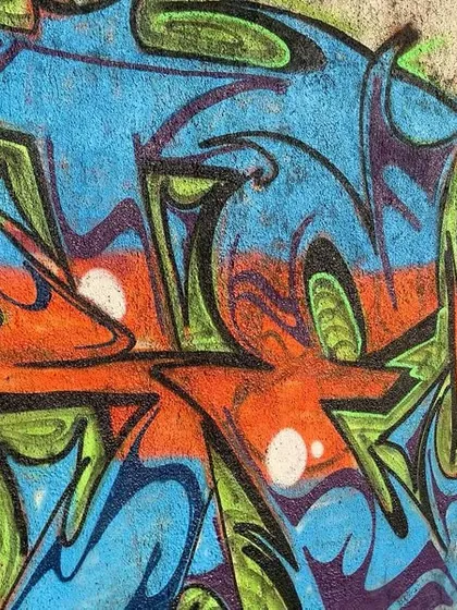 A close-up of the freestyle jam piece, showing the blend of different artists' styles and the raw energy of a collaborative wall.