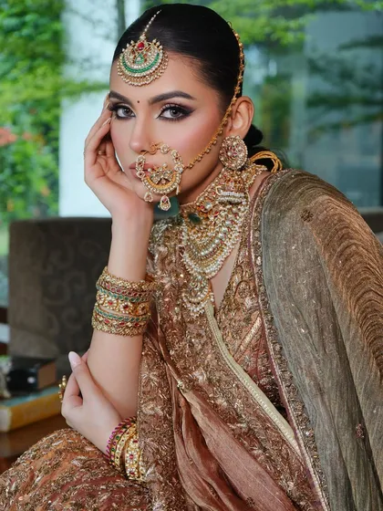 Another view of this regal look, highlighting the bride's majestic presence and the flawless draping of her dupattas.