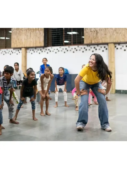 One of my team members, beaming with joy as she dances with the children. This photo perfectly shows the connection and happiness shared during these sessions.