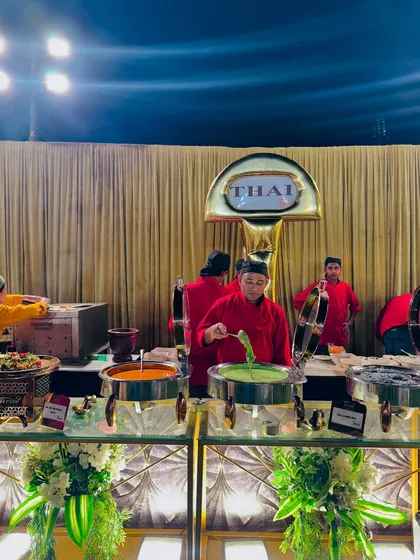 The live Thai food counter, where chefs serve a variety of authentic dishes, including vibrant red and green curries.