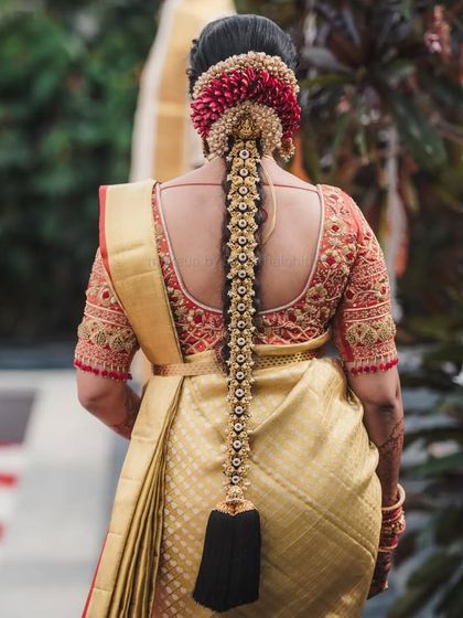 This is a quintessential South Indian muhurtham look. I created a flawless base with a bold red lip for Supritha, which stands out beautifully against her golden silk saree and traditional jewellery. The detailed bridal braid completes this timeless look.