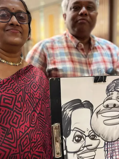 An older couple with their fun, exaggerated caricature.