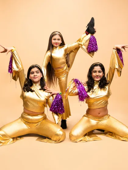 A dynamic pose from our disco fever routine. This performance showcases the flexibility and coordination our young students develop in their jazz classes.