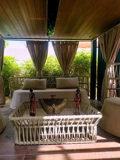 A closer look at the custom pergola lounge I created in Jaipur. The design features intricate woven furniture, soft, flowing curtains for privacy, and is surrounded by bamboo, creating an intimate and luxurious escape that feels like a private resort cabana.