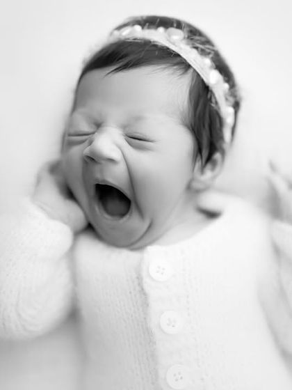 The same adorable yawn, this time in classic black and white. It gives the moment a timeless, artistic feel, focusing purely on the expression.