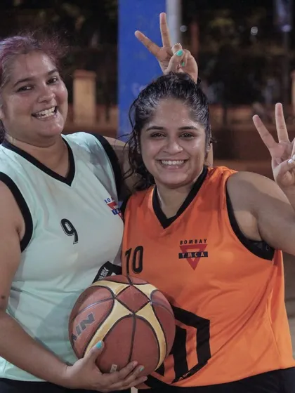 Two players from the Hooping Hotties sharing a fun moment. This team's name says it all.