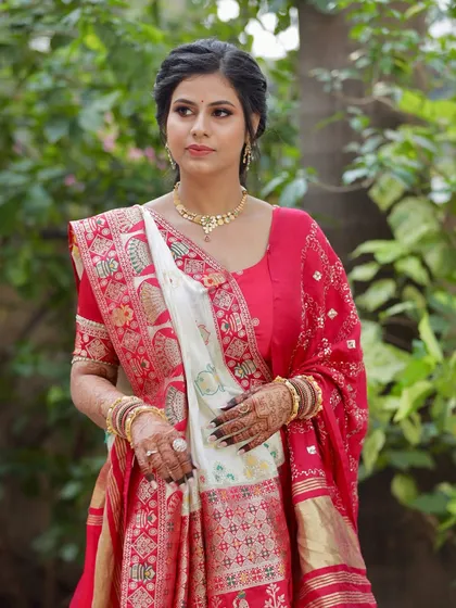 A classic portrait for her morning puja. The makeup is soft and traditional, paired with a beautiful red and white saree.