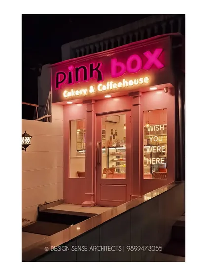 A slightly different angle of the facade at night. The combination of the main sign, window neon, and classic wall lanterns creates layers of light that make the bakery stand out.