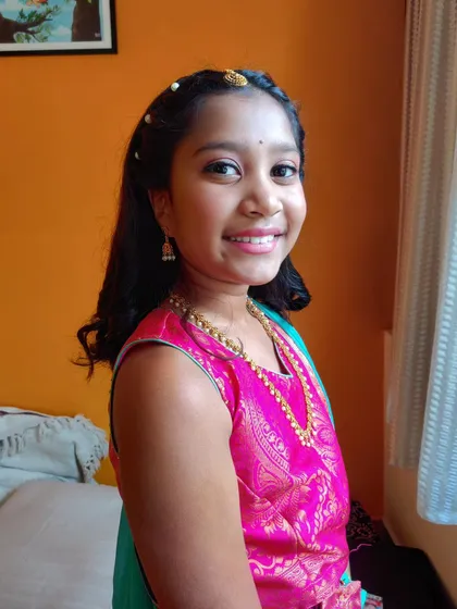 I absolutely adore styling my youngest clients. For her, we did a very simple and age-appropriate look with a touch of shimmer on the eyes, a light gloss, and a pretty hairstyle with pearl details to make her feel special for the family function.