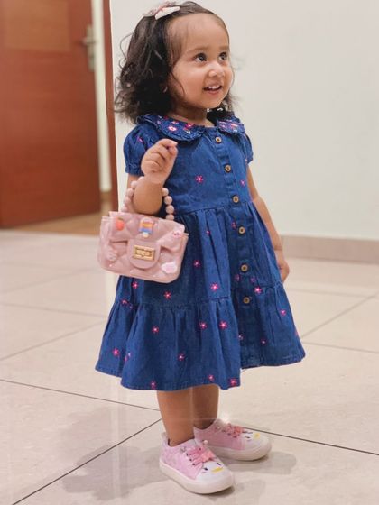 Another shot of my daughter in her cute summer denim dress from Firstcry. It's the perfect outfit for a sunny day out.
