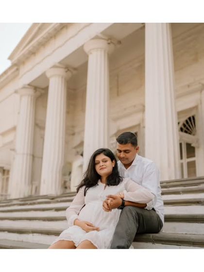 Seated on the steps of a grand old building, their love story feels both timeless and brand new.
