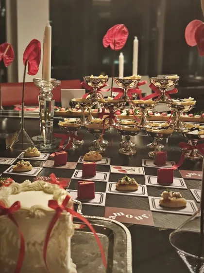 Another view of the romantic grazing table, showing the tiered silver platters and tall candles that added height and drama to the spread.