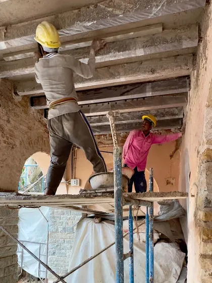 Another view of craftsmen restoring the wooden ceiling beams. This labor-intensive work is fundamental to structural conservation, ensuring the building is safe and sound for another century.