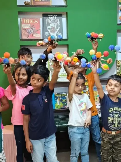 Our little astronomers proudly displaying the solar system models they built and painted themselves. This popular STEAM workshop combines learning about planets with hands-on assembly and creative painting.