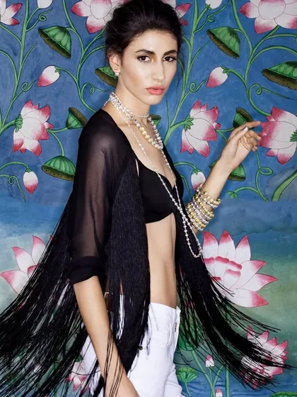 An editorial shot featuring bold pearl jewelry and a black fringe shawl. This look is an example of my art-deco inspired, high-fashion styling.