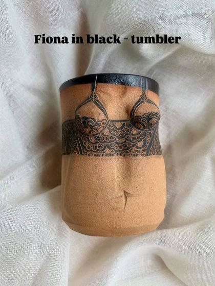 This is the 'Fiona' tumbler in black. The sgraffito technique used here involves carving through a layer of slip to reveal the clay body underneath, creating a striking visual texture.