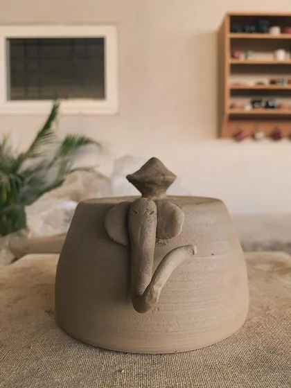 An elephant-handled lidded jar, raw and unglazed. The creativity in form and detail is wonderful to see.