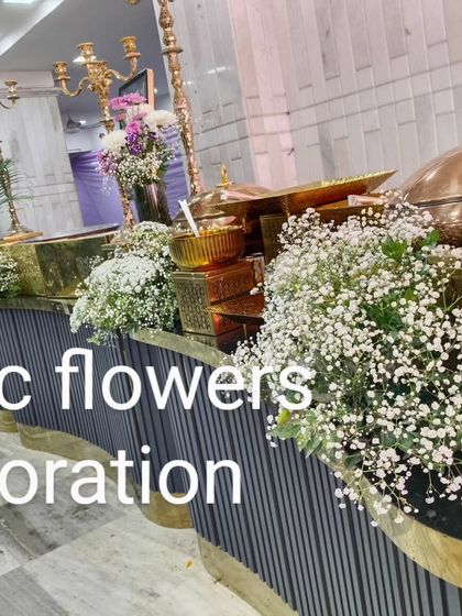 A simple yet elegant buffet decoration. We used clouds of baby's breath in pots to add a touch of softness and sophistication to the food service area.