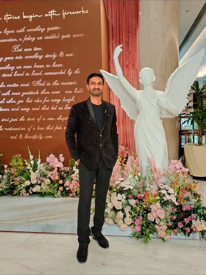 At the beautiful venue for a family function in Pune. The decor, with its floral arrangements and angel statue, was stunning.