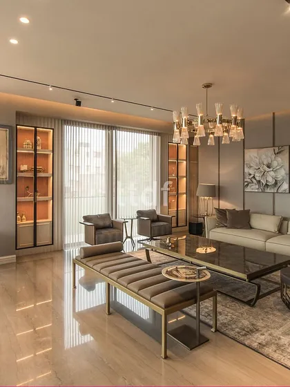 Within this lavish living room, an expansive layout sets the stage for notable artwork amidst a sophisticated muted color scheme. The ambiance exudes refinement, blending aesthetics with opulence seamlessly. Each detail contributes to an exalted atmosphere of elegance and luxury.