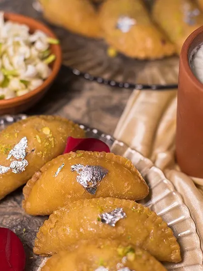 Our Holi special Gujiyas served alongside a glass of refreshing Thandai. It’s the ultimate festive combination.
