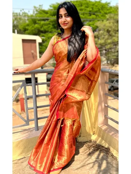 Another look at the radiant red and gold tissue cotton saree. It drapes beautifully and feels incredibly luxurious.