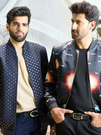 Two of my unique bomber jackets side-by-side: the navy jacket with gold detailing and the celestial-themed satin bomber. This shows the creative range within my outerwear collection.