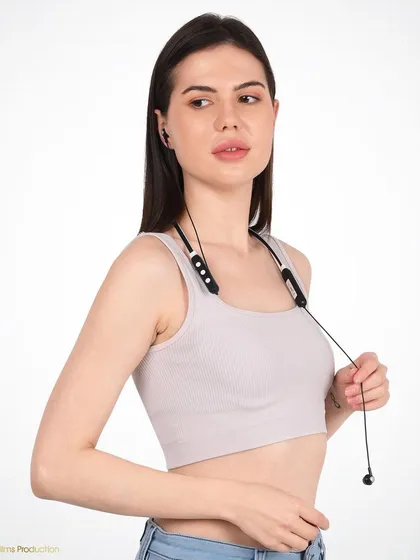 A lifestyle shot of a model wearing a neckband. This demonstrates the product in a real-world context, showing how it rests comfortably and stylishly on the user.