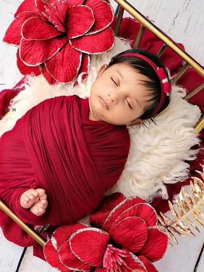 A top-down view of the baby in the golden bed, looking like royalty.