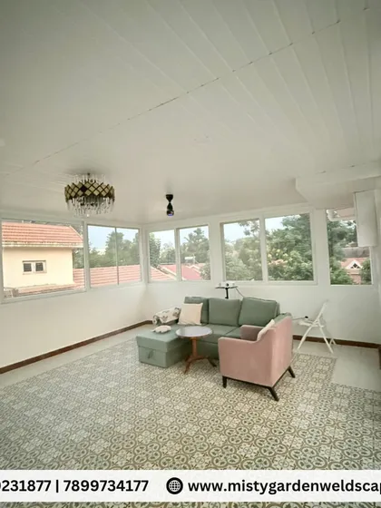 Imagine a bright, airy living room on your terrace. This is the interior of a fully enclosed gazebo, complete with a PVC ceiling, large UPVC windows, and stylish flooring. It's a perfect example of adding a functional and beautiful room to your home.