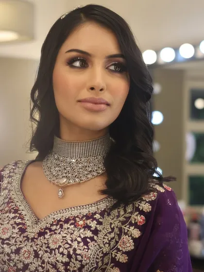 This reception look in a striking purple lehenga shows how to play with color. The student has perfectly balanced a shimmery eye with a soft lip, a key skill for modern evening events.