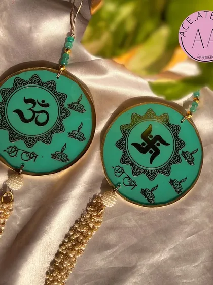 This set of circular turquoise hangings features Om and Swastik symbols. They offer a modern take on traditional door decor and are great for year-round positive vibes.