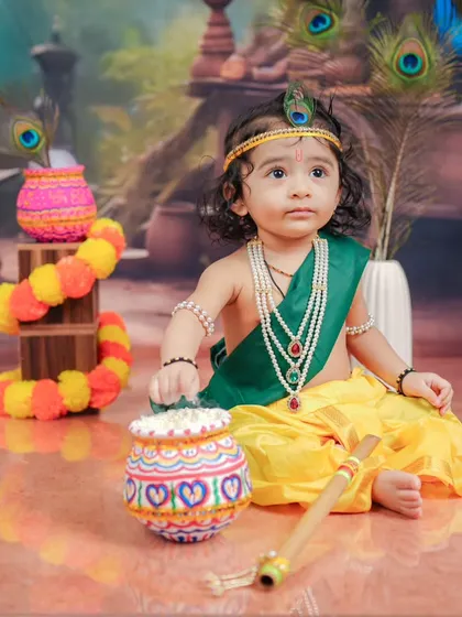 A playful moment with the matki of butter. I encourage kids to interact with the props to get natural and candid shots during the Janmashtami baby shoot.