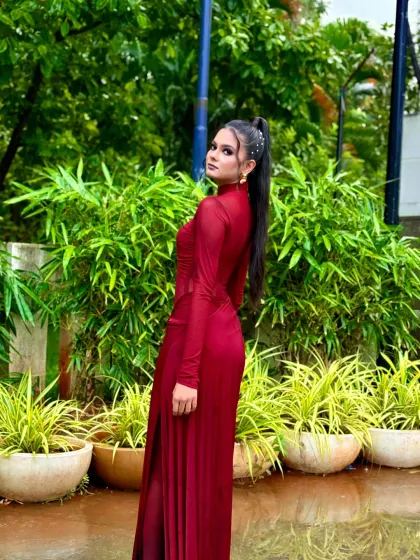 A profile view showcasing the high ponytail with pearl accessories, a popular choice for modern party hairstyles.