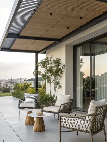 A cantilevered rafter pergola provides shade for this modern balcony. The design creates an open and unobstructed view, making the space feel larger while offering a comfortable spot to relax.