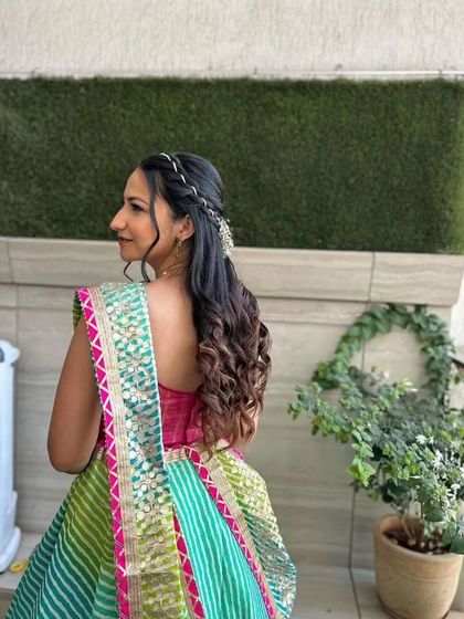 A back view of the half-up, half-down hairstyle, showing how it complements the traditional outfit.