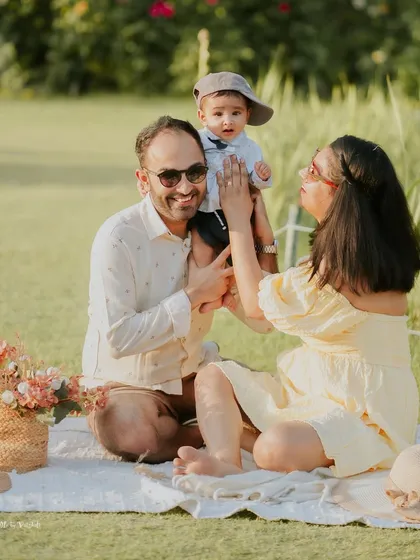 A perfect family picnic on a sunny day. For this outdoor family session in a Delhi NCR park, I used a simple setup with a blanket and basket to create a relaxed atmosphere for capturing candid moments of play and affection.