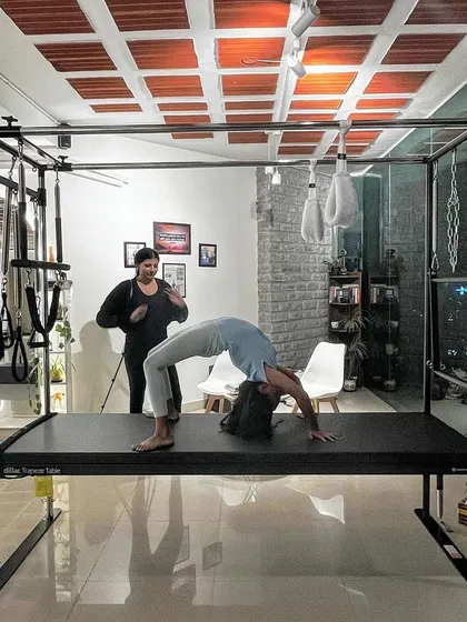 Empowering mother daughter moments. Here, an instructor guides her mother through a gentle backbend on the Cadillac, sharing the gift of wellness.