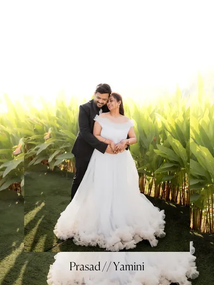 An intimate pre-wedding portrait of the couple embracing amidst lush green foliage, highlighting their connection in a natural setting.