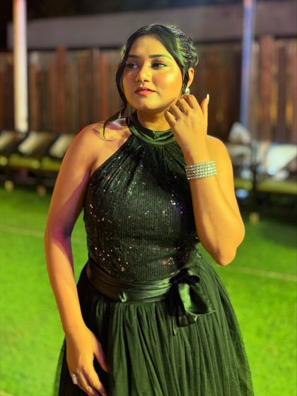 Posing outdoors in the black gown. Its timeless elegance makes it suitable for a variety of formal occasions, from award nights to cocktail parties.