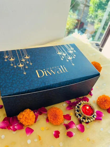 The elegant navy blue and gold box I use for the 'Khushiyon Ki Diwali' hamper, set against a festive backdrop.