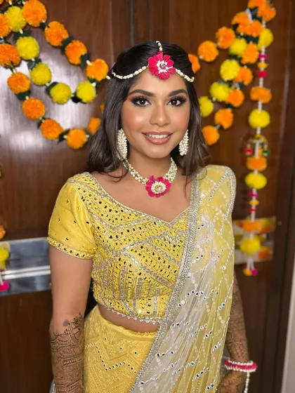 Mehendi ceremonies are all about color and joy. I gave Simran a fresh, dewy look with a pop of pink on the lips to match her floral jewelry and vibrant yellow lehenga, keeping it bright and perfect for the daytime celebration.