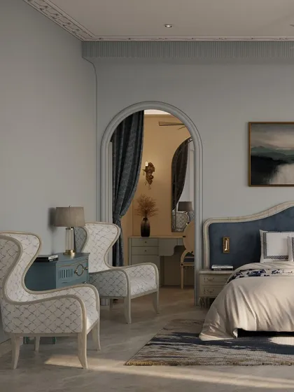 An archway provides a graceful transition from the bedroom into the dressing area, creating a sense of a private, luxurious suite. The wingback chairs add a touch of classic elegance.