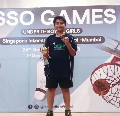 Zidan Shaikh proudly posing with his trophy and medal from the ISSO Games.