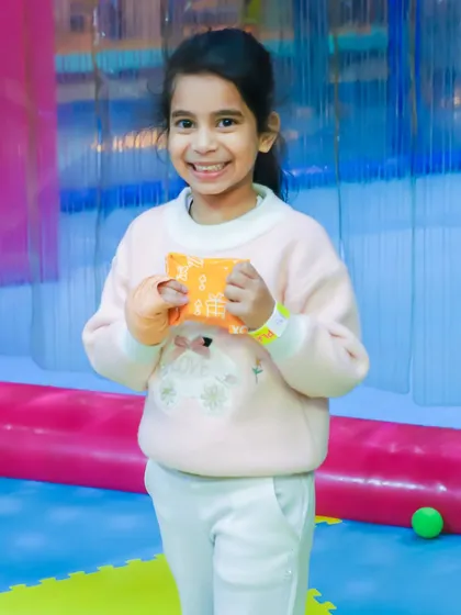 A happy girl enjoying her time at Play Box, made even better with our seasonal fun passes.