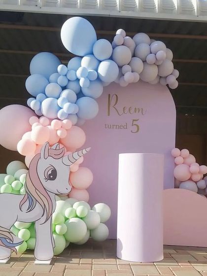 A simple and sweet outdoor unicorn setup in pastel colors, perfect for a smaller gathering or a garden party.