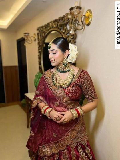 The side profile of this bride shows the harmony of the complete look. The elegant hair, the flawless skin, and the rich color of her outfit all work together to create a picture of bridal perfection.