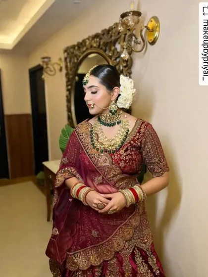 The side profile of this bride shows the harmony of the complete look. The elegant hair, the flawless skin, and the rich color of her outfit all work together to create a picture of bridal perfection.